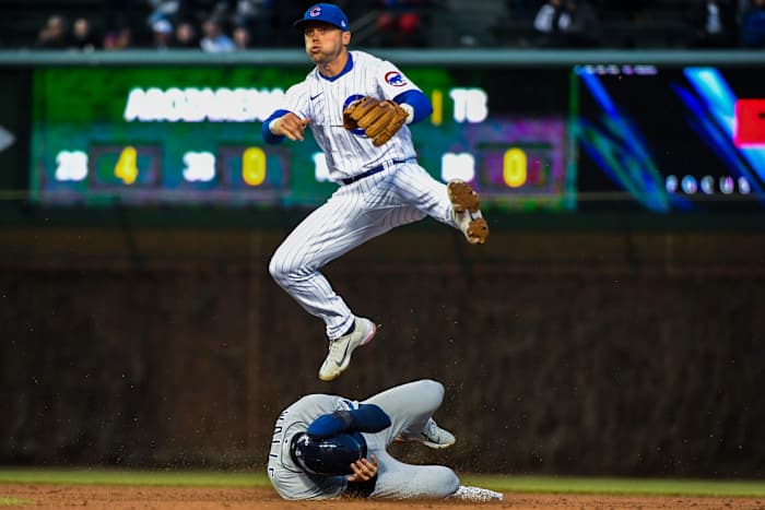 Nico Hoerner throws the ball to first base.